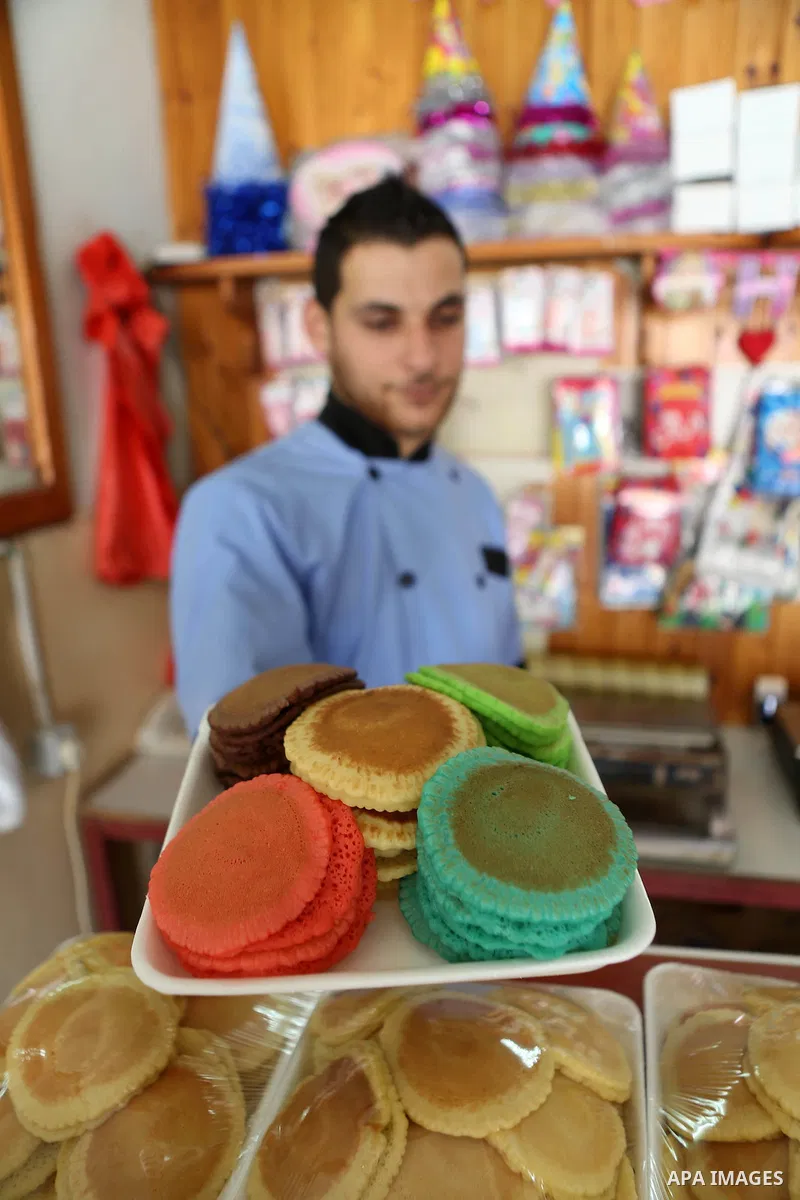 A Palestinian man prepares traditional pancakes known as ''Qatayef" at his shop during the Muslim holy fasting month of Ramadan in the West Bank village of Ein Yabrud near Ramallah on June, 21, 2016. Ramadan is sacred to...