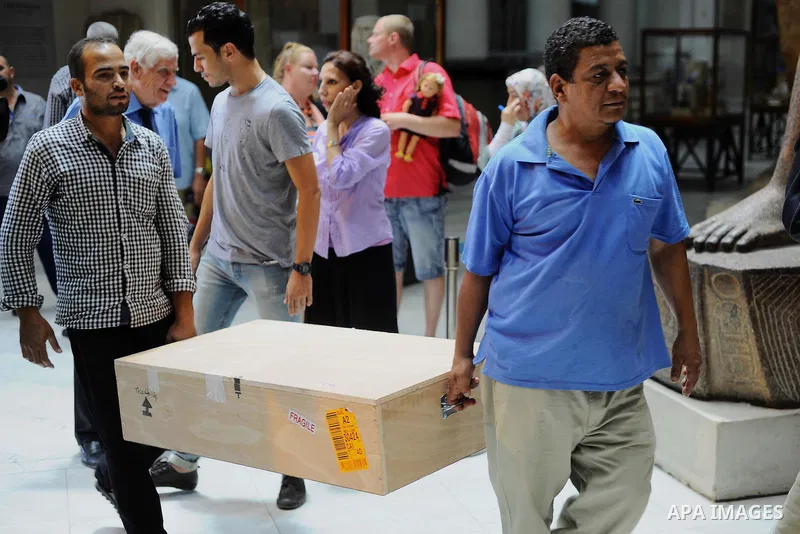 Egyptian antiquities officials carry a lid of a sarcophagus on its arrival to the Egyptian Museum in Cairo, Egypt, on June 21, 2016. Two ancient Egyptian sarcophagus covers have been delivered to Cairo's Egyptian Museum...