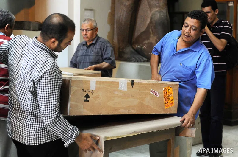 Egyptian antiquities officials carry a lid of a sarcophagus on its arrival to the Egyptian Museum in Cairo, Egypt, on June 21, 2016. Two ancient Egyptian sarcophagus covers have been delivered to Cairo's Egyptian Museum...