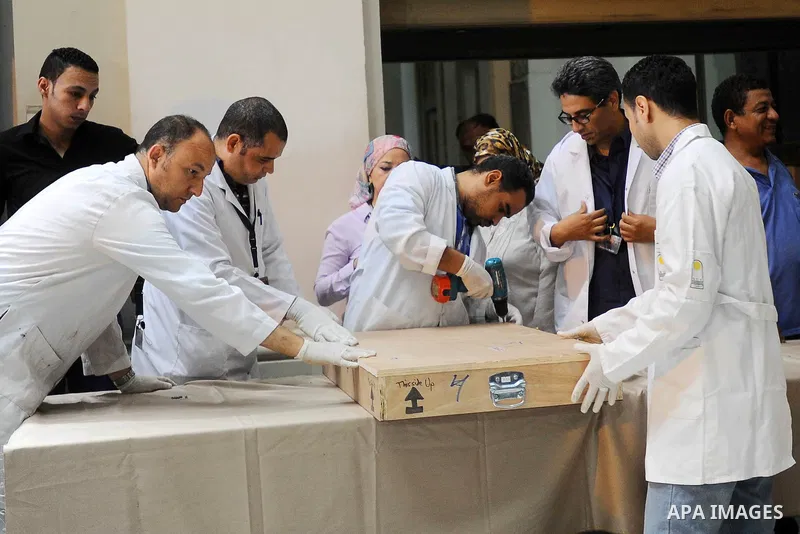 Egyptian antiquities officials carry a lid of a sarcophagus on its arrival to the Egyptian Museum in Cairo, Egypt, on June 21, 2016. Two ancient Egyptian sarcophagus covers have been delivered to Cairo's Egyptian Museum...