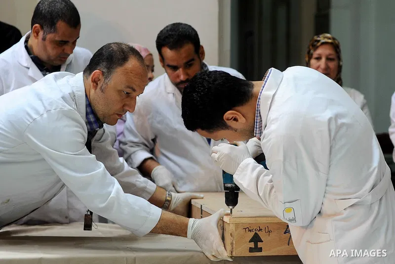 Egyptian antiquities officials carry a lid of a sarcophagus on its arrival to the Egyptian Museum in Cairo, Egypt, on June 21, 2016. Two ancient Egyptian sarcophagus covers have been delivered to Cairo's Egyptian Museum...