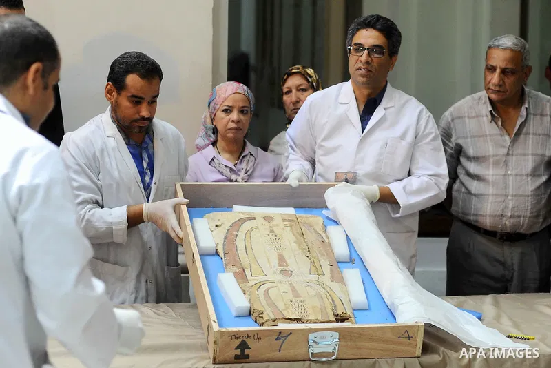 Egyptian antiquities officials inspect a sarcophagus cover on its arrival to the Egyptian Museum in Cairo, Egypt, on June 21, 2016. Two ancient Egyptian sarcophagus covers have been delivered to Cairo's Egyptian Museum a...