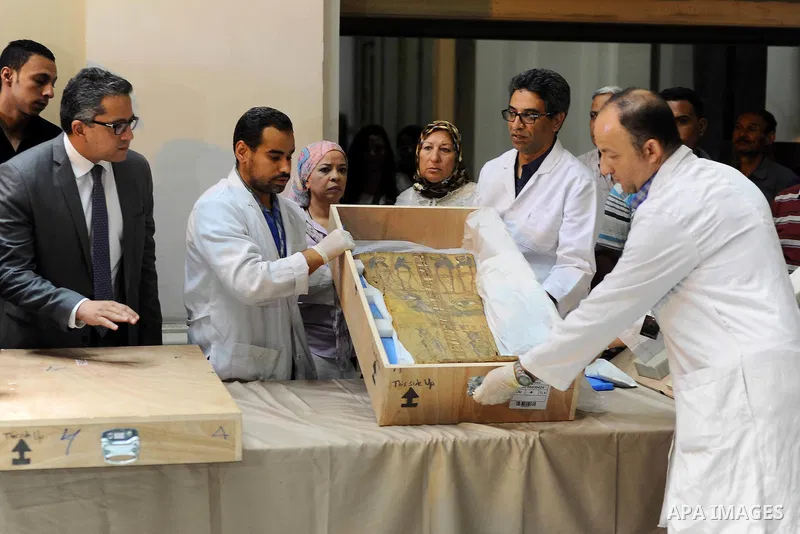 Egyptian antiquities officials inspect a sarcophagus cover on its arrival to the Egyptian Museum in Cairo, Egypt, on June 21, 2016. Two ancient Egyptian sarcophagus covers have been delivered to Cairo's Egyptian Museum a...