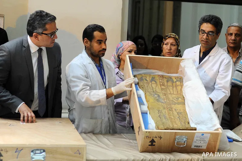 Egyptian antiquities officials inspect a sarcophagus cover on its arrival to the Egyptian Museum in Cairo, Egypt, on June 21, 2016. Two ancient Egyptian sarcophagus covers have been delivered to Cairo's Egyptian Museum a...