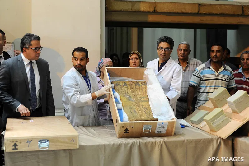 Egyptian antiquities officials inspect a sarcophagus cover on its arrival to the Egyptian Museum in Cairo, Egypt, on June 21, 2016. Two ancient Egyptian sarcophagus covers have been delivered to Cairo's Egyptian Museum a...