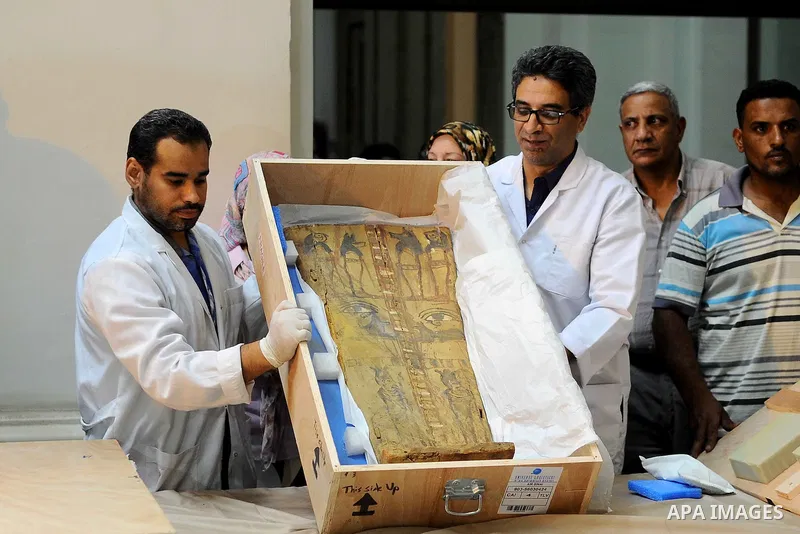 Egyptian antiquities officials inspect a sarcophagus cover on its arrival to the Egyptian Museum in Cairo, Egypt, on June 21, 2016. Two ancient Egyptian sarcophagus covers have been delivered to Cairo's Egyptian Museum a...