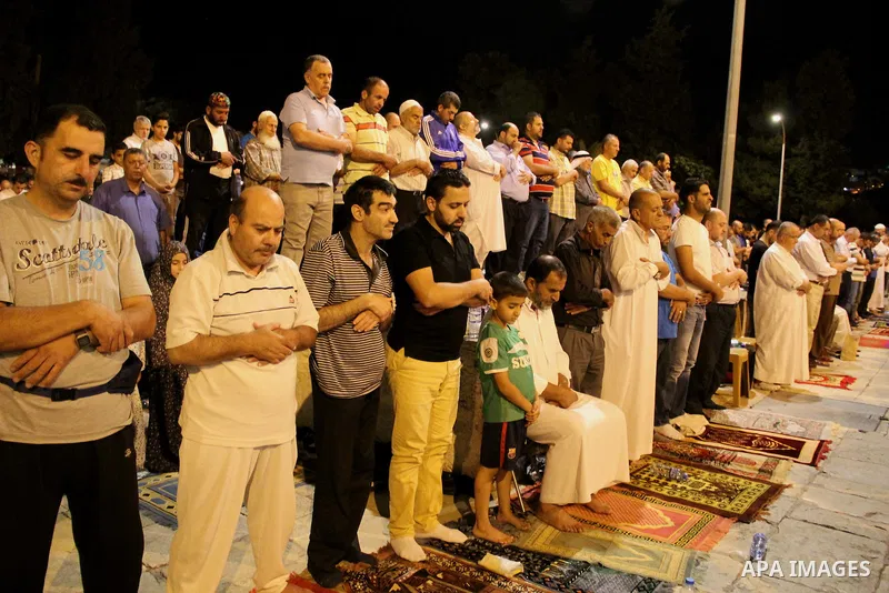 Palestinian Muslim worshippers perform "Taraweeh", nightly prayer of the month of Ramadan, in front of the Dome of the Rock mosque, in Jerusalem's old city on June 21, 2016. Ramadan is sacred to Muslims because it is dur...