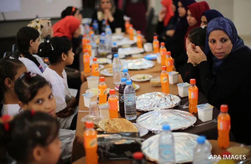 Palestinian orphan children break their fast during the holy fasting month of Ramadan in Gaza city on June 22, 2016. Ramadan is sacred to Muslims because it is during that month that tradition says the Koran was revealed...