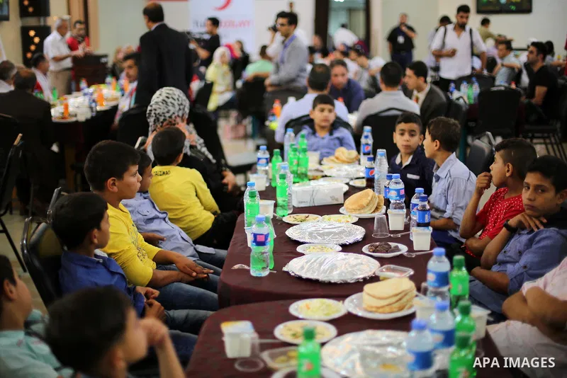Palestinian orphan children break their fast during the holy fasting month of Ramadan in Gaza city on June 22, 2016. Ramadan is sacred to Muslims because it is during that month that tradition says the Koran was revealed...