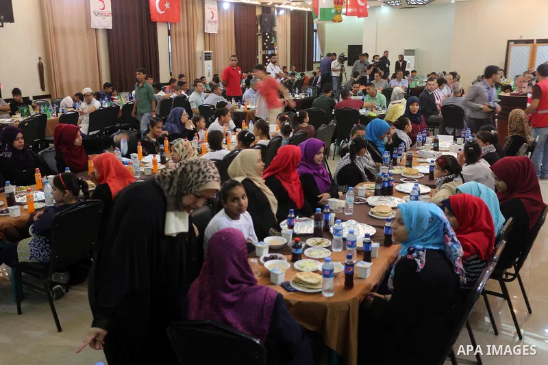 Palestinian orphan children break their fast during the holy fasting month of Ramadan in Gaza city on June 22, 2016. Ramadan is sacred to Muslims because it is during that month that tradition says the Koran was revealed...