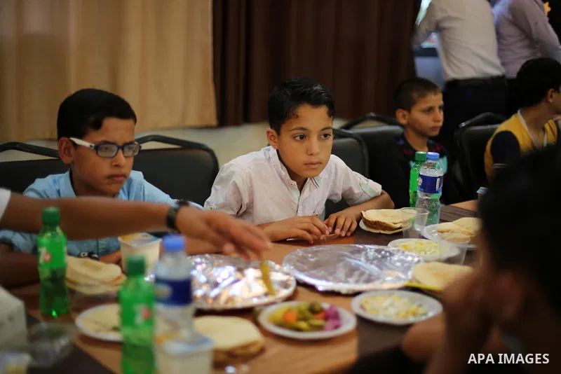 Palestinian orphan children break their fast during the holy fasting month of Ramadan in Gaza city on June 22, 2016. Ramadan is sacred to Muslims because it is during that month that tradition says the Koran was revealed...