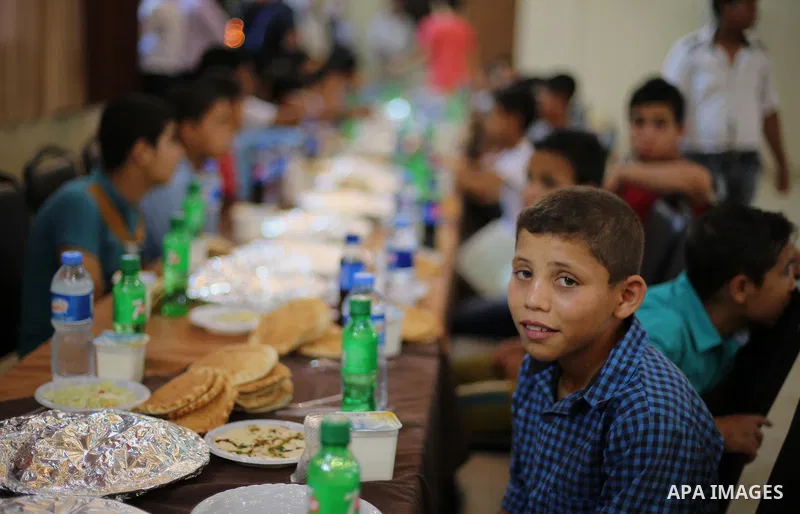 Palestinian orphan children break their fast during the holy fasting month of Ramadan in Gaza city on June 22, 2016. Ramadan is sacred to Muslims because it is during that month that tradition says the Koran was revealed...