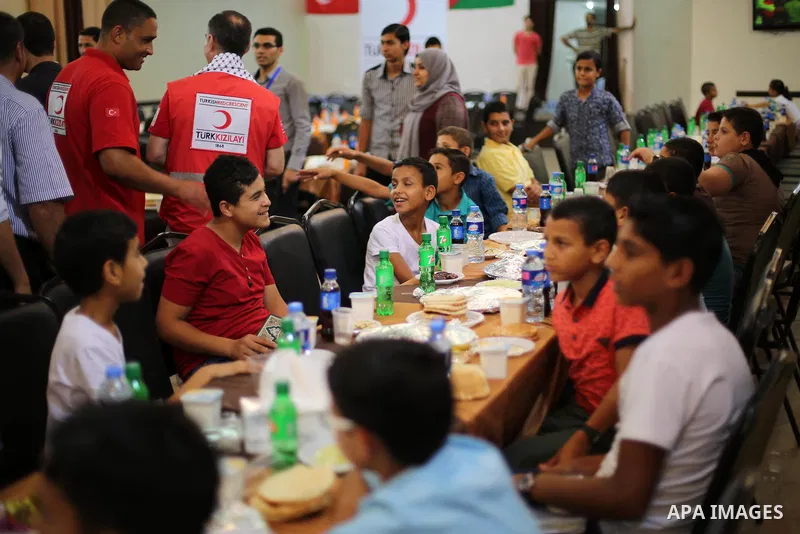Palestinian orphan children break their fast during the holy fasting month of Ramadan in Gaza city on June 22, 2016. Ramadan is sacred to Muslims because it is during that month that tradition says the Koran was revealed...