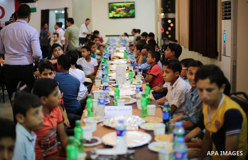 Palestinian orphan children break their fast during the holy fasting month of Ramadan in Gaza city on June 22, 2016. Ramadan is sacred to Muslims because it is during that month that tradition says the Koran was revealed...