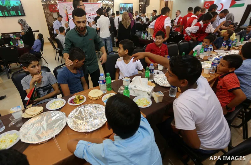 Palestinian orphan children break their fast during the holy fasting month of Ramadan in Gaza city on June 22, 2016. Ramadan is sacred to Muslims because it is during that month that tradition says the Koran was revealed...