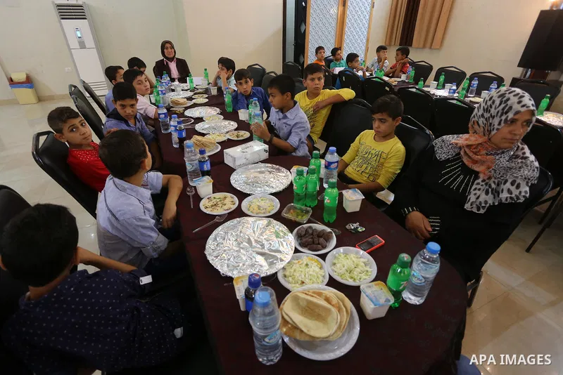 Palestinian orphan children break their fast during the holy fasting month of Ramadan in Gaza city on June 22, 2016. Ramadan is sacred to Muslims because it is during that month that tradition says the Koran was revealed...