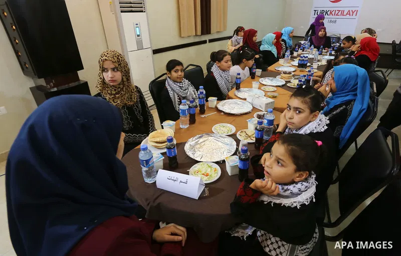 Palestinian orphan children break their fast during the holy fasting month of Ramadan in Gaza city on June 22, 2016. Ramadan is sacred to Muslims because it is during that month that tradition says the Koran was revealed...