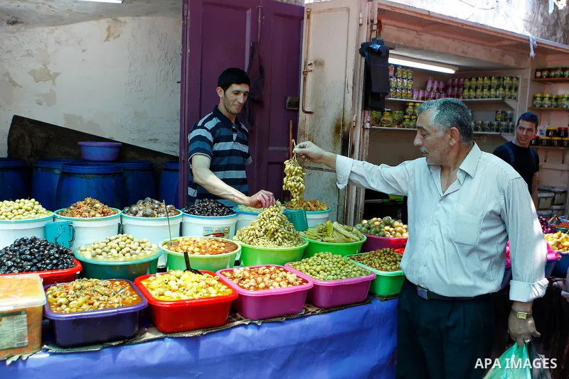 A Palestinian man sells pickles on the holy month of Ramadan at market in the Old City of the West Bank town of Hebron on June 22, 2016. Ramadan is sacred to Muslims because it is during that month that tradition says th...