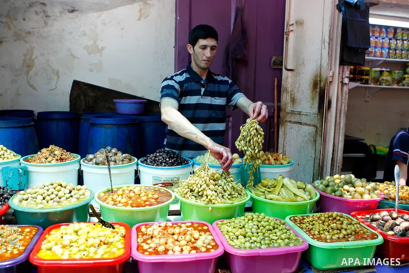 A Palestinian man sells pickles on the holy month of Ramadan at market in the Old City of the West Bank town of Hebron on June 22, 2016. Ramadan is sacred to Muslims because it is during that month that tradition says th...