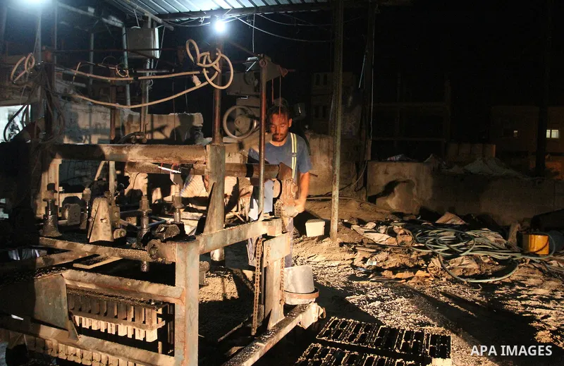 Palestinian labourers work at a cement factory at night to avoid the day time heat in Rafah in the southern Gaza Strip on June 22, 2016 during Islam's holy fasting month of Ramadan. Ramadan is sacred to Muslims because i...