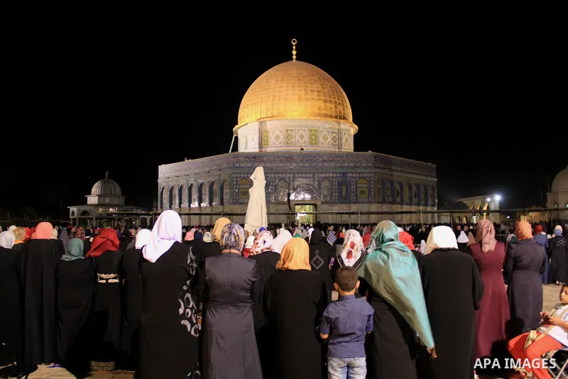 Palestinian Muslim worshippers perform "Taraweeh", nightly prayer of the month of Ramadan, in front of the Dome of the Rock mosque, in Jerusalem's old city on June 22, 2016. Ramadan is sacred to Muslims because it is dur...