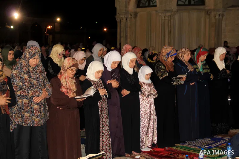 Palestinian Muslim worshippers perform "Taraweeh", nightly prayer of the month of Ramadan, in front of the Dome of the Rock mosque, in Jerusalem's old city on June 22, 2016. Ramadan is sacred to Muslims because it is dur...