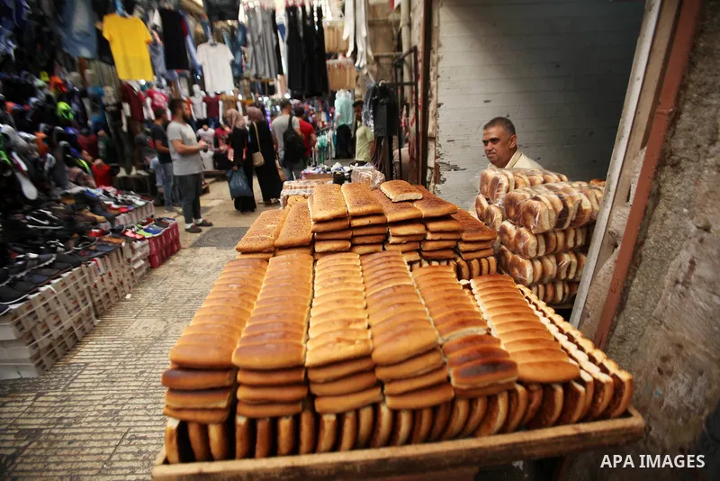 A Palestinian vendor sells breads in a street market on the holy month of Ramadan, in the West Bank city of Nablus on June 23, 2016. Ramadan is sacred to Muslims because it is during that month that tradition says the Ko...
