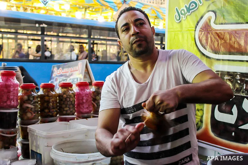 An Egyptian vendor sells pickles at a street market on the holy month of Ramadan, in the Cairo, Egypt, on June 23, 2016. Ramadan is sacred to Muslims because it is during that month that tradition says the Koran was reve...