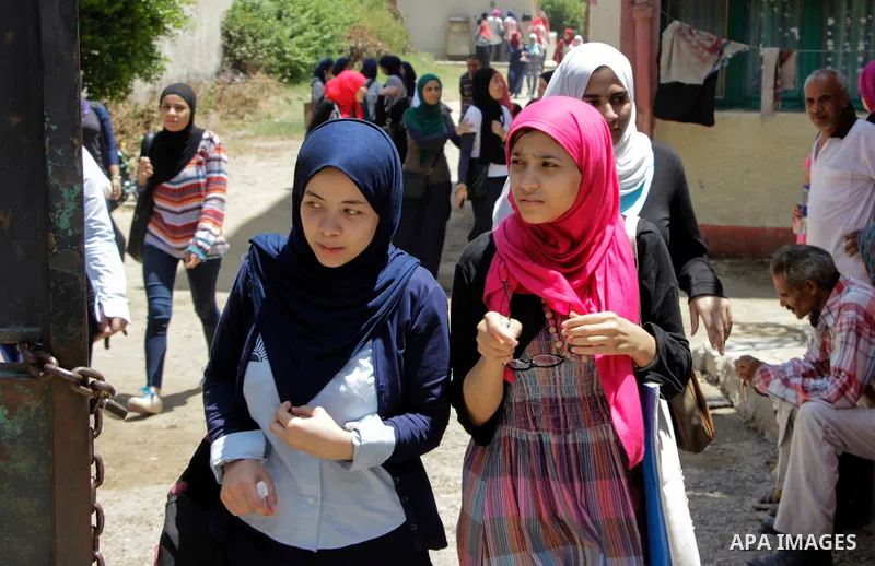 Egyptian students walk outside their school following a high school exams in Cairo, Egypt, June 23, 2016. From June 5 till 28, some 560,000 Egyptian students have to pass these exams which lead to the Egyptian General Se...