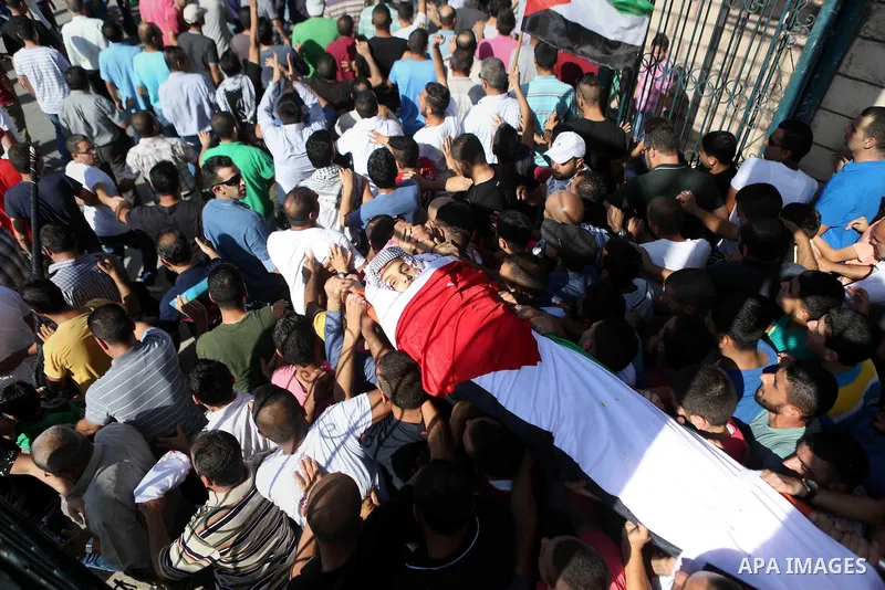 Mourners carry the body of Palestinian boy Mahmoud Badran, 15, who was killed by Israeli troops on Tuesday, during his funeral in the village of Beit Ore-Tahta near the West Bank city of Ramallah June 23, 2016. Photo by...