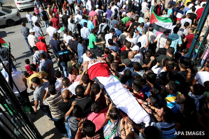 Mourners carry the body of Palestinian boy Mahmoud Badran, 15, who was killed by Israeli troops on Tuesday, during his funeral in the village of Beit Ore-Tahta near the West Bank city of Ramallah June 23, 2016. Photo by...