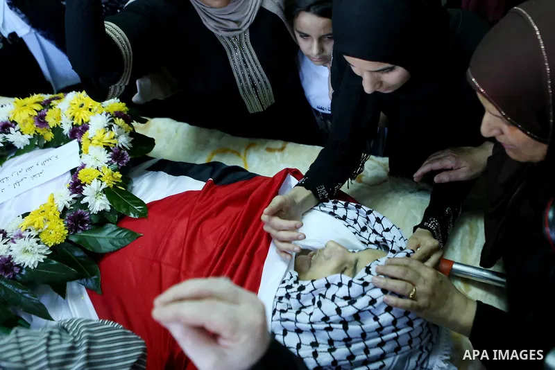 Relatives of Palestinian boy Mahmoud Badran, 15, who was killed by Israeli troops on Tuesday, mourn during his funeral in the village of Beit Ore-Tahta near the West Bank city of Ramallah June 23, 2016. Photo by Shadi Ha...