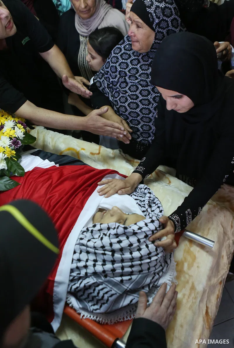 Relatives of Palestinian boy Mahmoud Badran, 15, who was killed by Israeli troops on Tuesday, mourn during his funeral in the village of Beit Ore-Tahta near the West Bank city of Ramallah June 23, 2016. Photo by Shadi Ha...