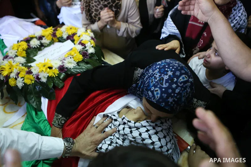 Relatives of Palestinian boy Mahmoud Badran, 15, who was killed by Israeli troops on Tuesday, mourn during his funeral in the village of Beit Ore-Tahta near the West Bank city of Ramallah June 23, 2016. Photo by Shadi Ha...