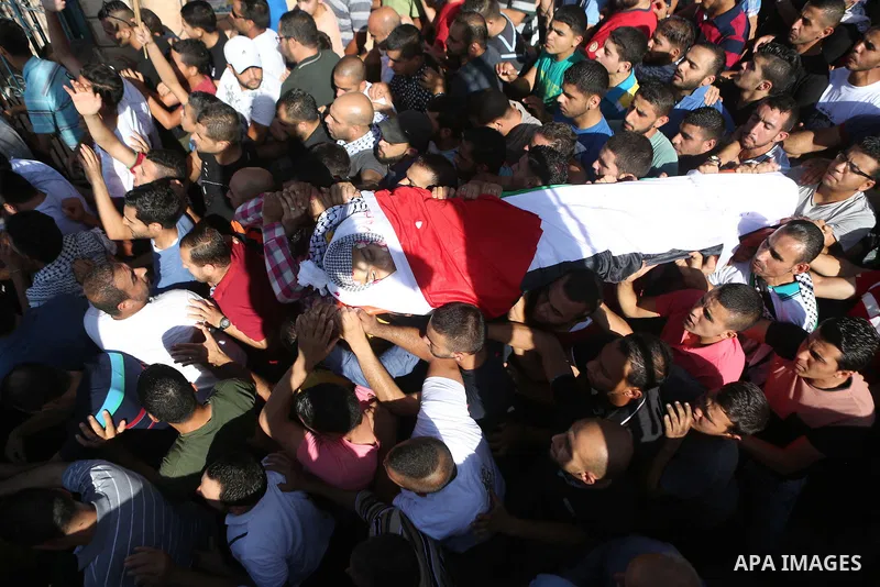 Mourners carry the body of Palestinian boy Mahmoud Badran, 15, who was killed by Israeli troops on Tuesday, during his funeral in the village of Beit Ore-Tahta near the West Bank city of Ramallah June 23, 2016. Photo by...