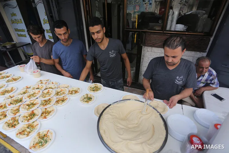 Palestinians prepare chickpeas known as hummus for breakfasting during the holy fasting month of Ramadan in Gaza city, on June 23, 2016. Muslims around the world refrain from eating, drinking and sexual intercourse from...