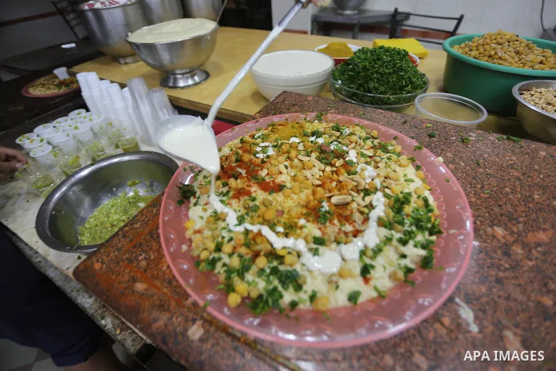 Palestinians prepare chickpeas known as hummus for breakfasting during the holy fasting month of Ramadan in Gaza city, on June 23, 2016. Muslims around the world refrain from eating, drinking and sexual intercourse from...