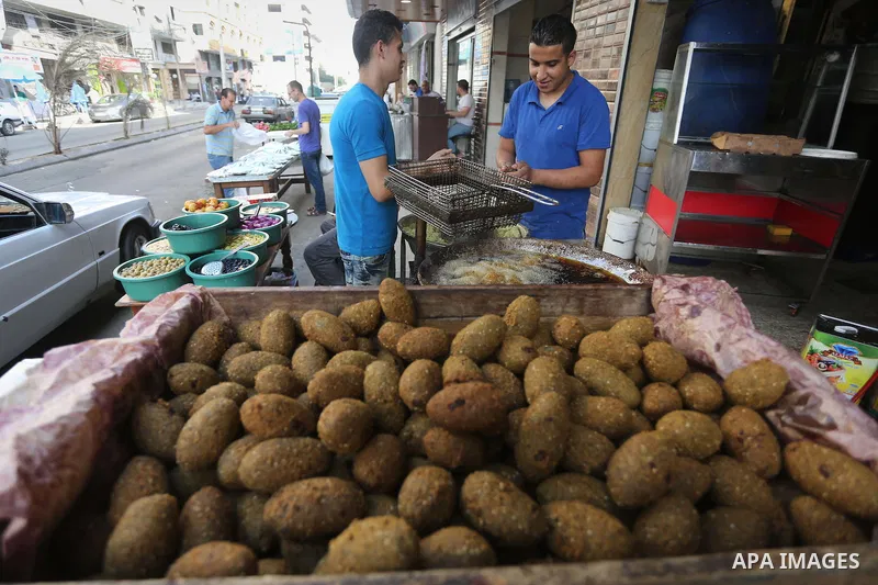 Palestinians prepare chickpeas known as Falafel for breakfasting during the holy fasting month of Ramadan in Gaza city, on June 23, 2016. Muslims around the world refrain from eating, drinking and sexual intercourse from...