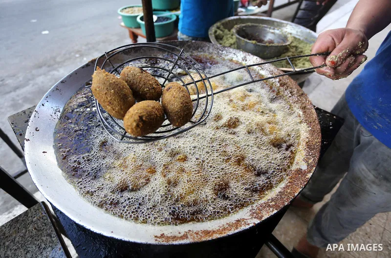 Palestinians prepare chickpeas known as Falafel for breakfasting during the holy fasting month of Ramadan in Gaza city, on June 23, 2016. Muslims around the world refrain from eating, drinking and sexual intercourse from...