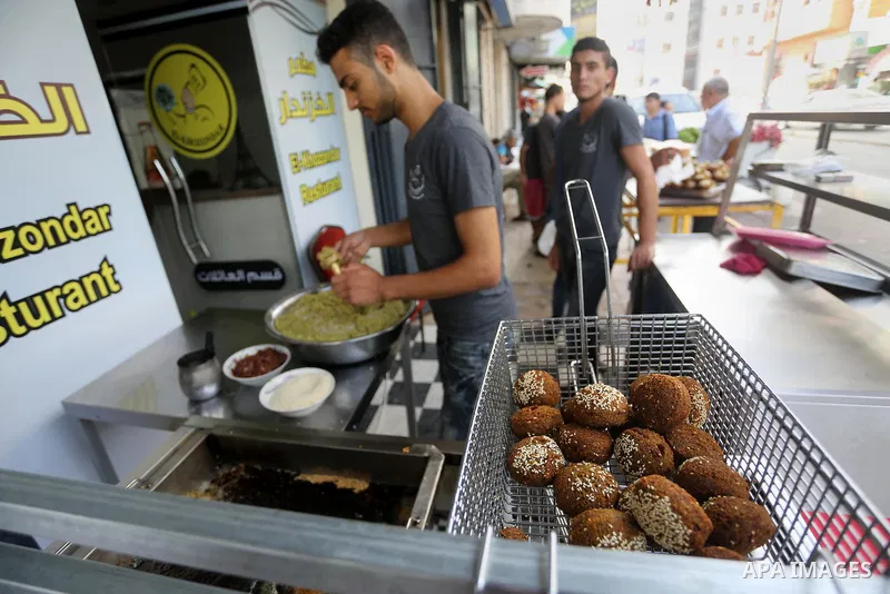 Palestinians prepare chickpeas known as Falafel for breakfasting during the holy fasting month of Ramadan in Gaza city, on June 23, 2016. Muslims around the world refrain from eating, drinking and sexual intercourse from...