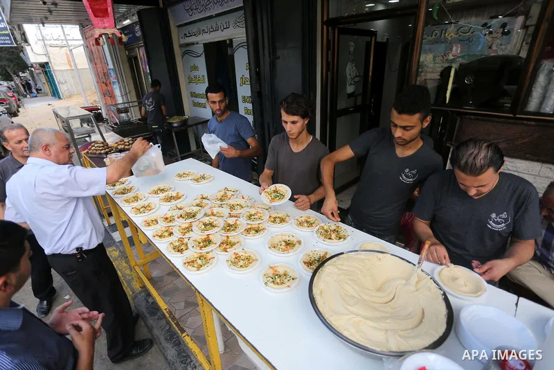 Palestinians prepare chickpeas known as hummus for breakfasting during the holy fasting month of Ramadan in Gaza city, on June 23, 2016. Muslims around the world refrain from eating, drinking and sexual intercourse from...