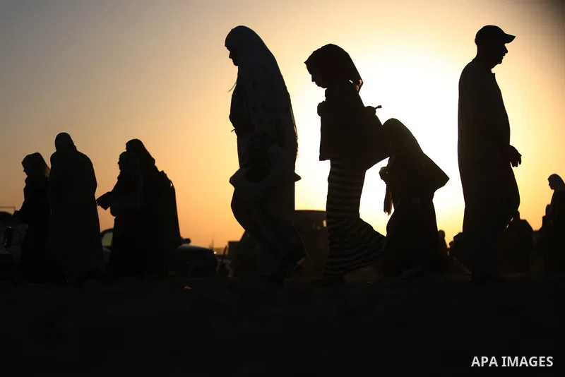 Palestinians walk past Qalandia checkpoint between the West Bank city of Ramallah and Jerusalem on June 24, 2016, as they head to Jerusalem's Al-Aqsa mosque for the third Friday prayer of the holy Muslim fasting month of...