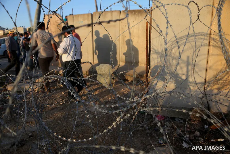 Palestinians walk past Qalandia checkpoint between the West Bank city of Ramallah and Jerusalem on June 24, 2016, as they head to Jerusalem's Al-Aqsa mosque for the third Friday prayer of the holy Muslim fasting month of...