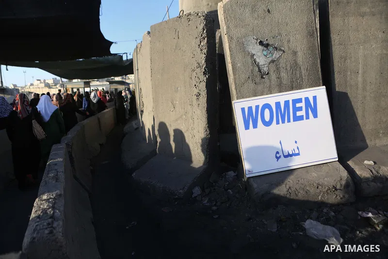 Palestinians walk past Qalandia checkpoint between the West Bank city of Ramallah and Jerusalem on June 24, 2016, as they head to Jerusalem's Al-Aqsa mosque for the third Friday prayer of the holy Muslim fasting month of...