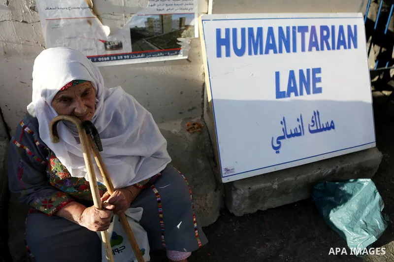 A Palestinian woman waits past Qalandia checkpoint between the West Bank city of Ramallah and Jerusalem on June 24, 2016, as she head to Jerusalem's Al-Aqsa mosque for the third Friday prayer of the holy Muslim fasting m...