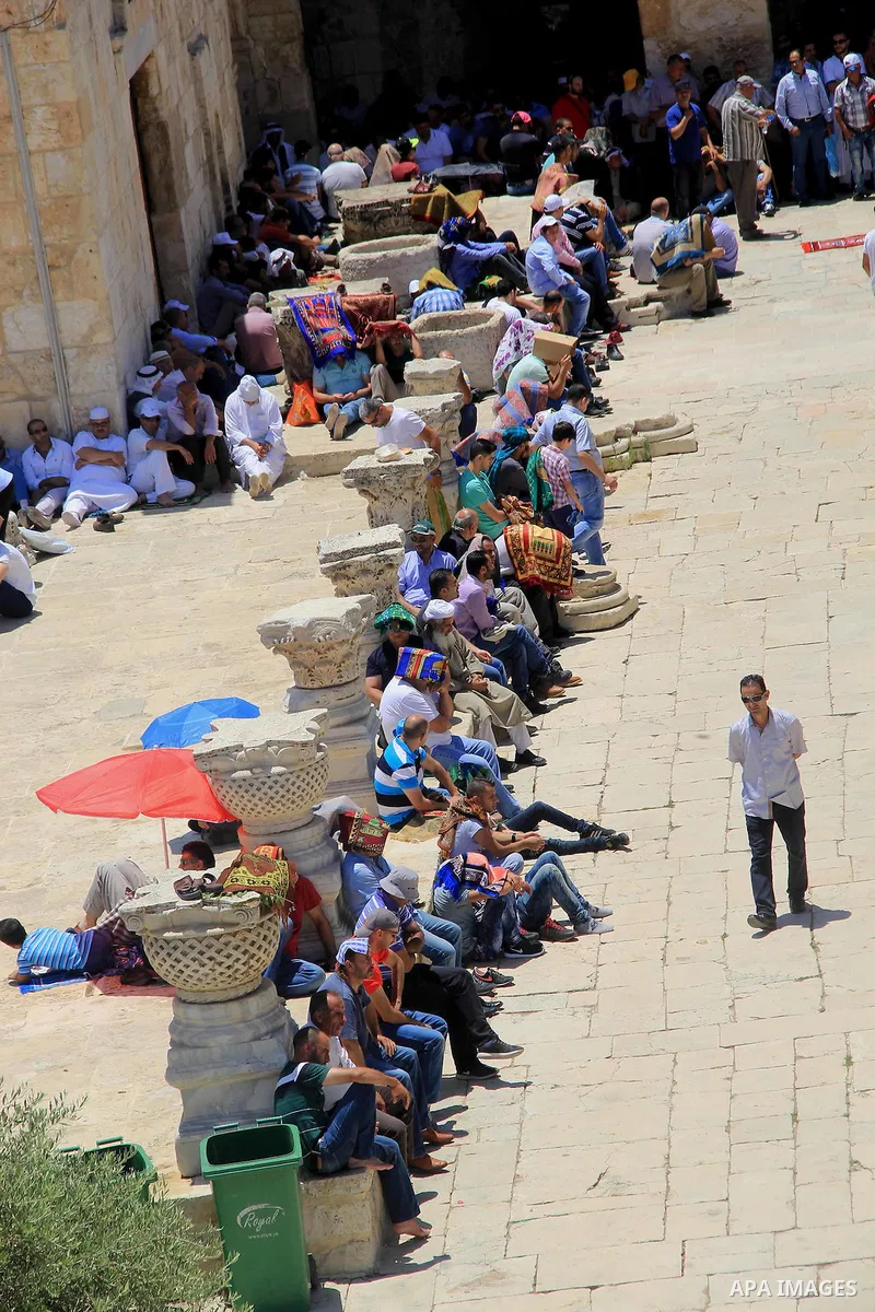 Palestinian Muslim worshippers perform Friday prayer in front of the Dome of the Rock mosque at the al-Aqsa mosque compound in Jerusalem's old city on June 24, 2016 during the holy fasting month of Ramadan. Photo by Mahf...