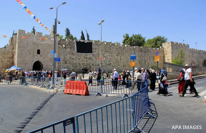 Palestinian men spray water on children to cool them down before prayers on the third Friday of the holy month of Ramadan near the Dome of the Rock, on the compound known to Muslims as Noble Sanctuary and to Jews as Temp...