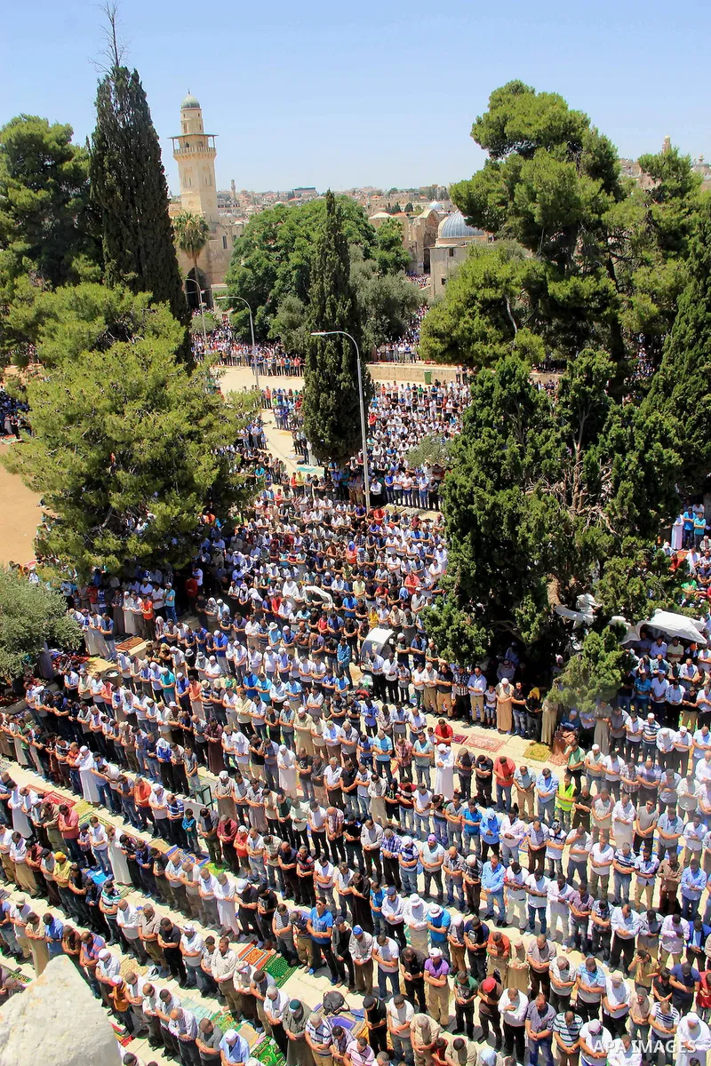 Palestinian Muslim worshippers perform Friday prayer in front of the Dome of the Rock mosque at the al-Aqsa mosque compound in Jerusalem's old city on June 24, 2016 during the holy fasting month of Ramadan. Photo by Mahf...