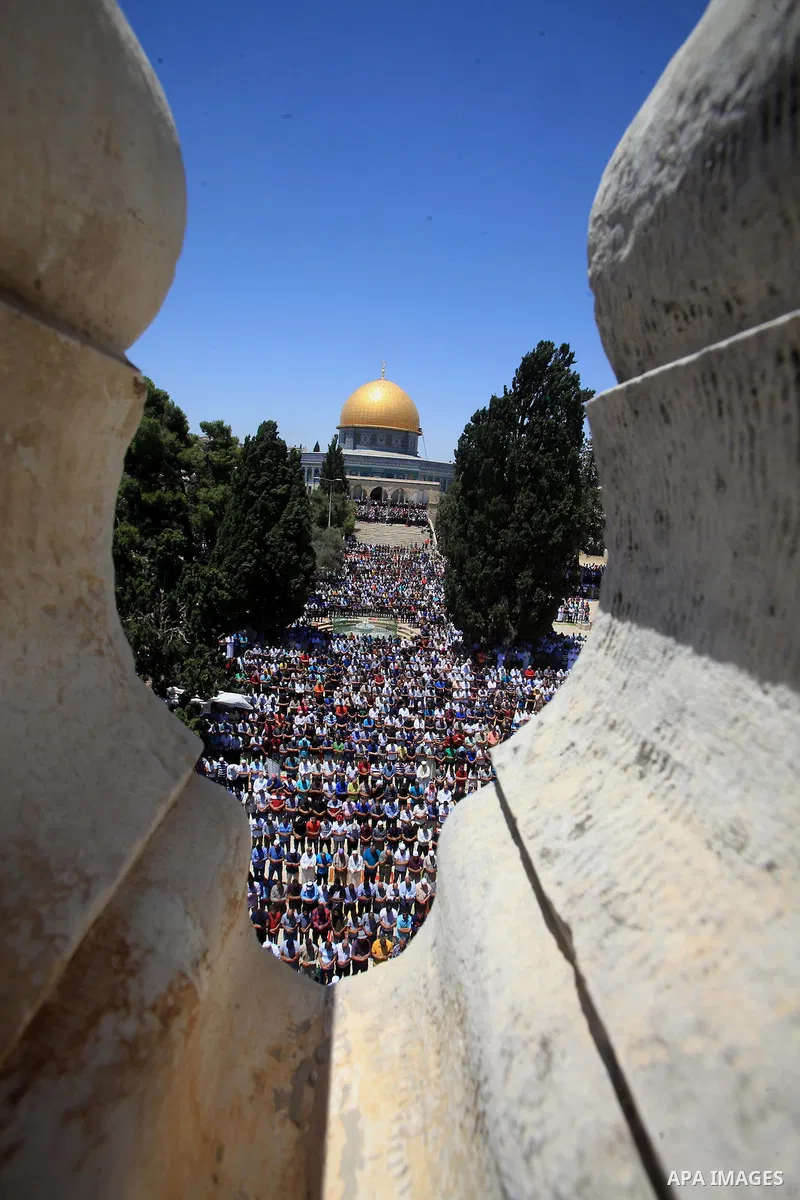 Palestinian Muslim worshippers perform Friday prayer in front of the Dome of the Rock mosque at the al-Aqsa mosque compound in Jerusalem's old city on June 24, 2016 during the holy fasting month of Ramadan. Photo by Mahf...
