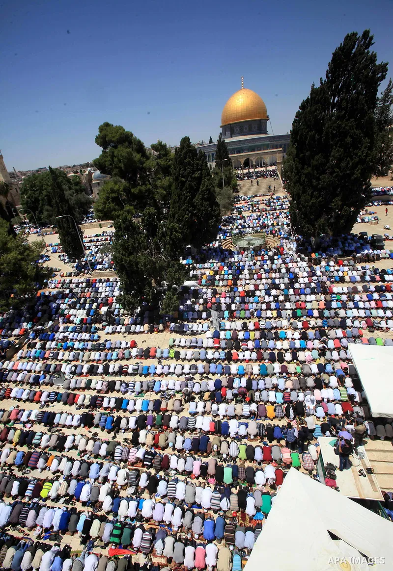 Palestinian Muslim worshippers perform Friday prayer in front of the Dome of the Rock mosque at the al-Aqsa mosque compound in Jerusalem's old city on June 24, 2016 during the holy fasting month of Ramadan. Photo by Mahf...
